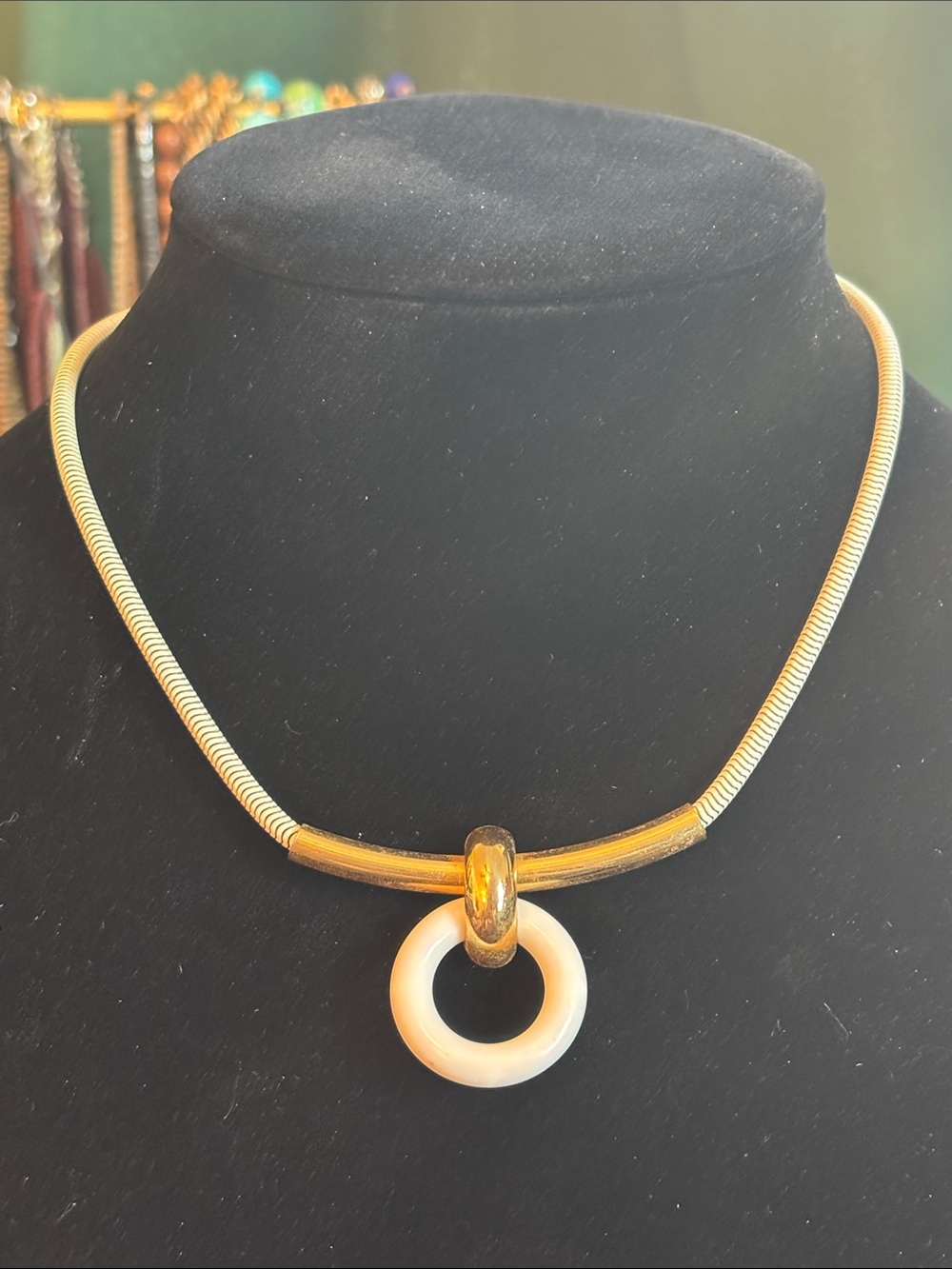 Gold Tone Necklace with White Circular Pendant and White Chain